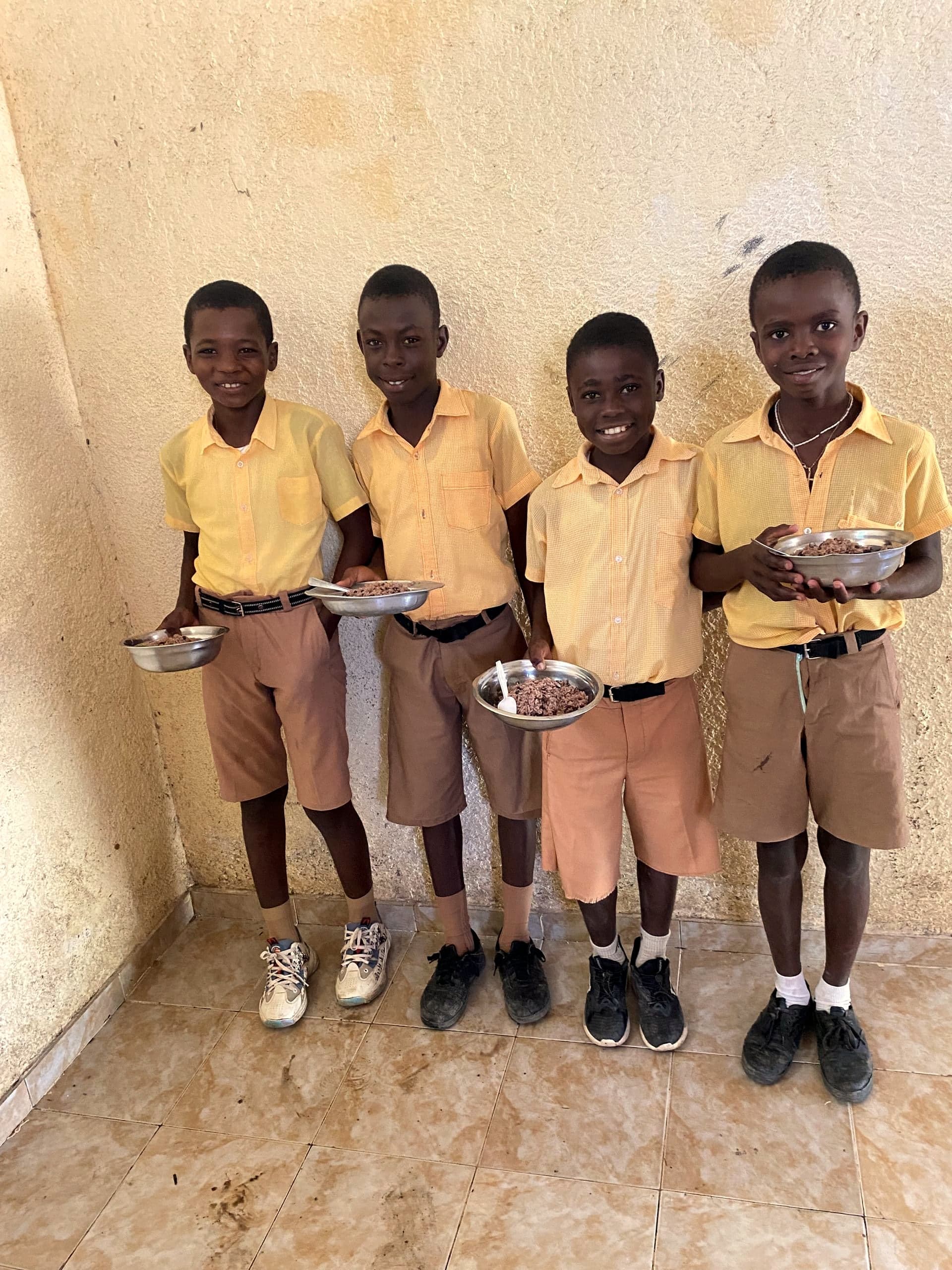 Boys at an HEF school sharing a meal together