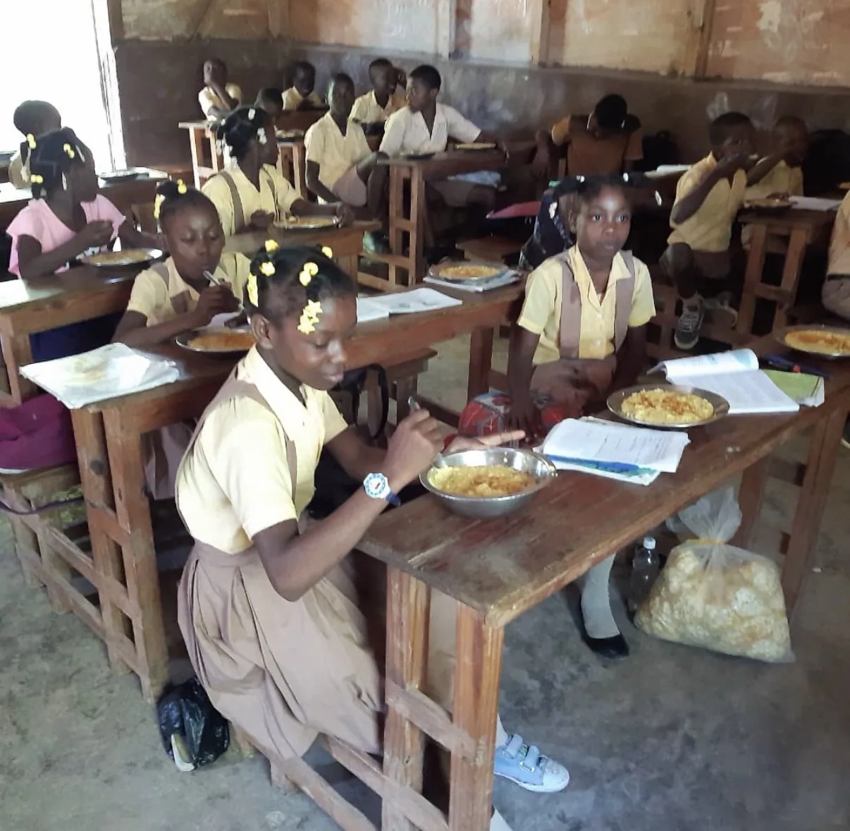 Students eat a meal at their desks in an HEF classroom